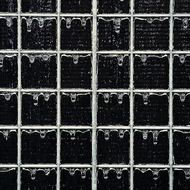 Condenser coil heavily blocked with dirt, restricting airflow